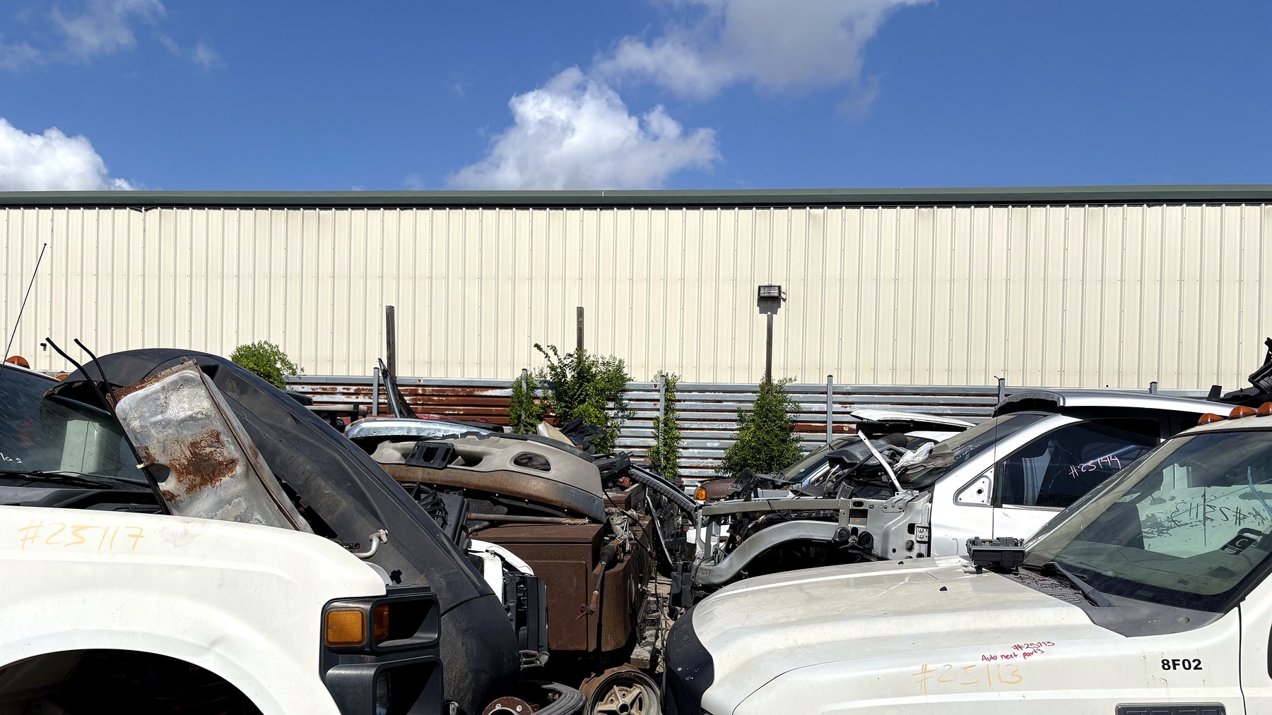 Used diesel truck parts staged in the NEXT Auto Parts yard